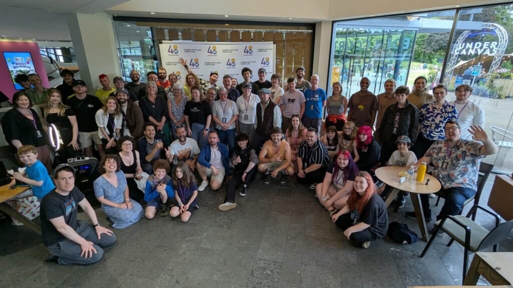 Image of a crowd of people in front of sign that says 48 Hour Film Project.