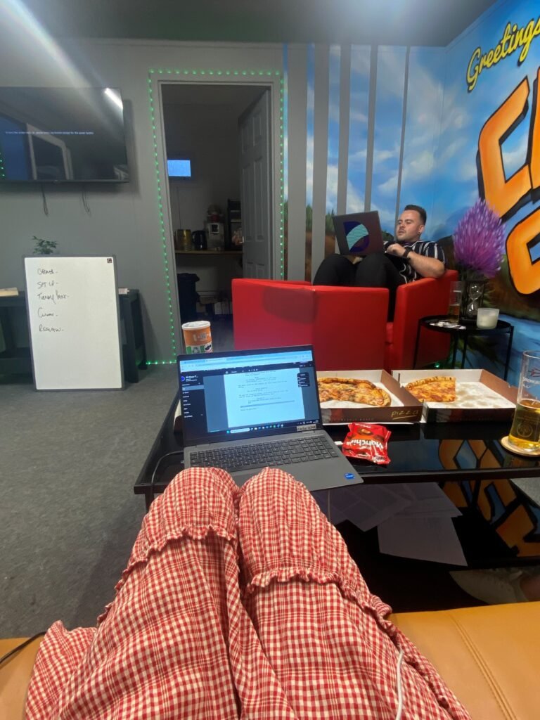 Image of laptop, pizza and people writing a script.